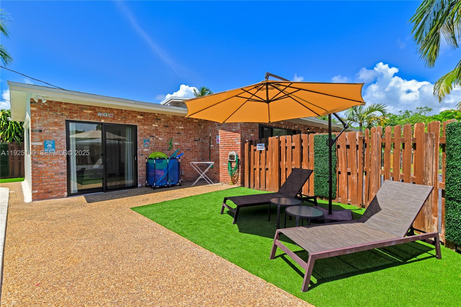 1204 Northeast 7th Street Pompano Beach, FL 33060 - Photo 39 of 43 a view of patio with a table and chairs under an umbrella