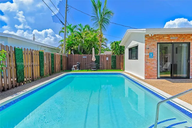a view of pool with lawn chairs and couches