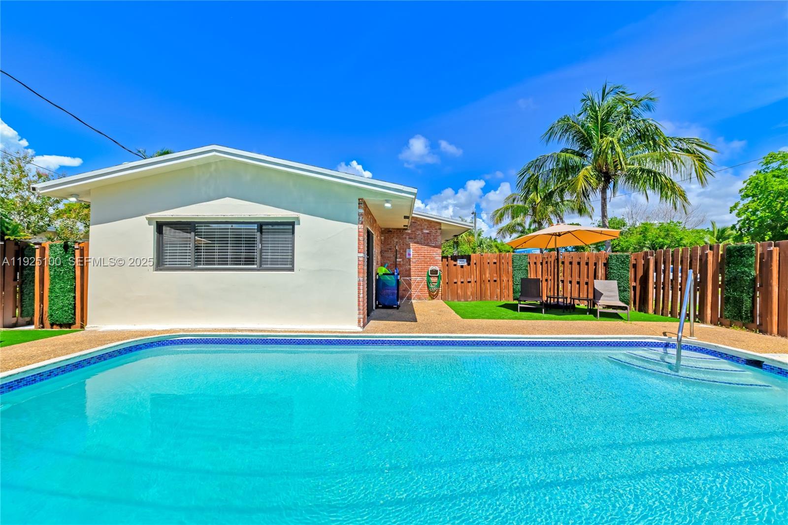 1204 Northeast 7th Street Pompano Beach, FL 33060 - Photo 42 of 43 a view of pool with lawn chairs and couches