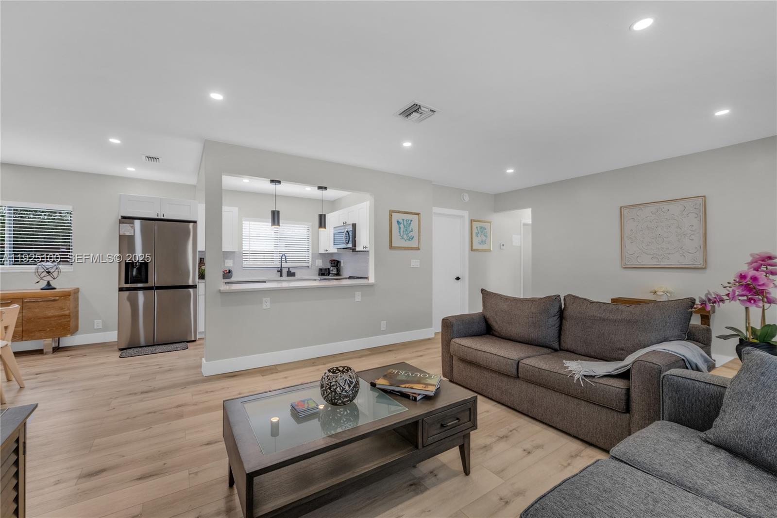 1204 Northeast 7th Street Pompano Beach, FL 33060 - Photo 7 of 43 a living room with furniture and kitchen view