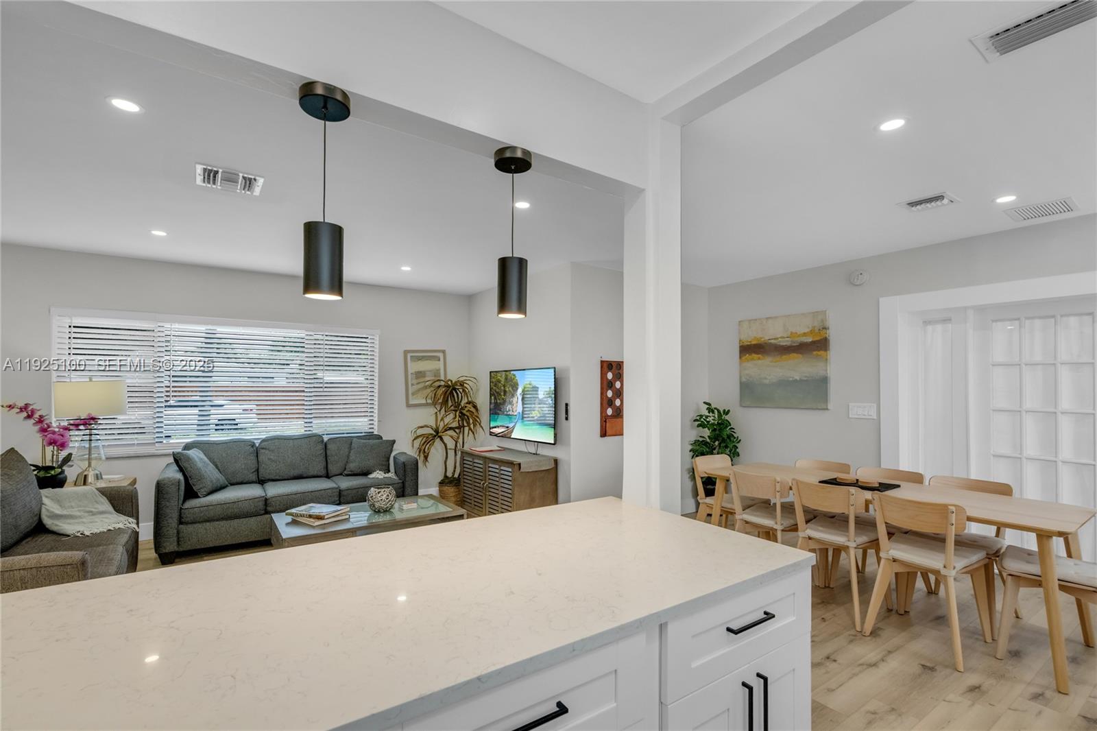 1204 Northeast 7th Street Pompano Beach, FL 33060 - Photo 10 of 43 a living room with furniture kitchen view and a large window