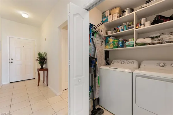 a view of storage and utility room with washer and dryer