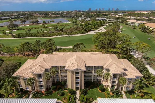 an aerial view of a house with a yard and lake view