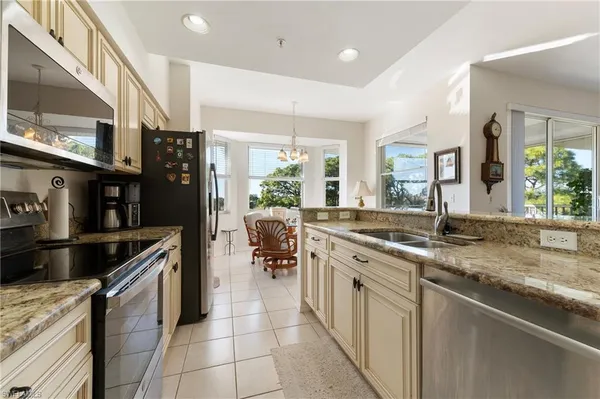a kitchen with stainless steel appliances granite countertop a sink and a stove