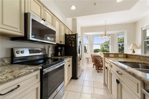 a kitchen with stainless steel appliances granite countertop a sink and stove top oven