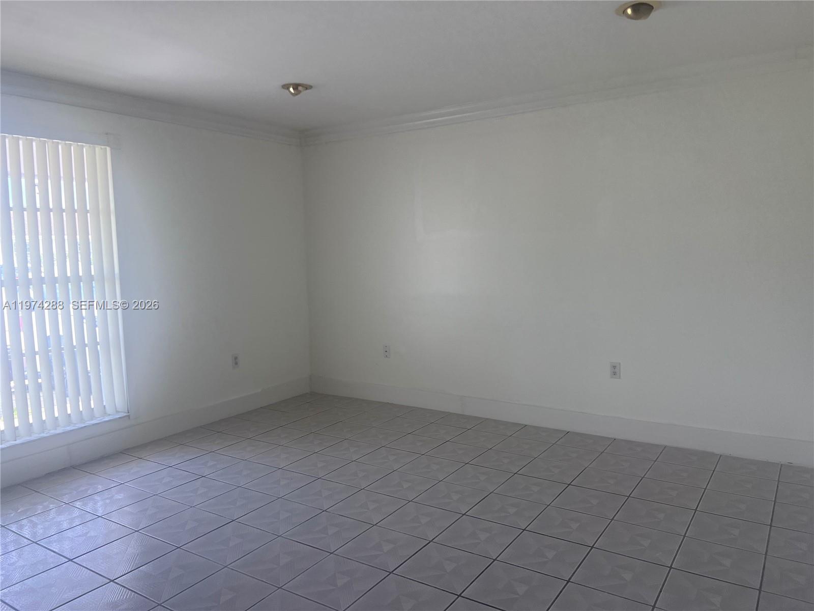 26120 Southwest 130th Avenue Homestead, FL 33032 - Photo 13 of 34 an empty room with windows