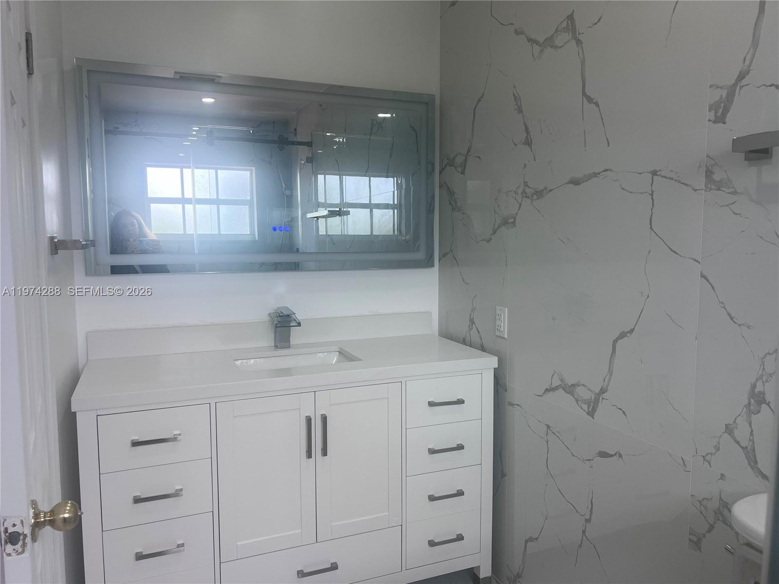 26120 Southwest 130th Avenue Homestead, FL 33032 - Photo 22 of 34 a kitchen with a sink and cabinets