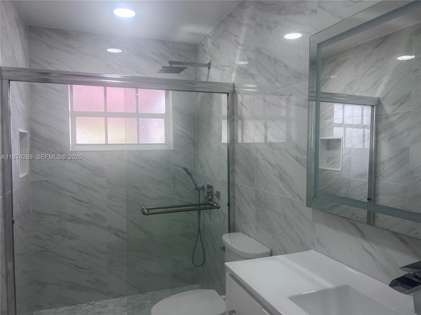 26120 Southwest 130th Avenue Homestead, FL 33032 - Photo 24 of 34 a bathroom with a shower and toilet