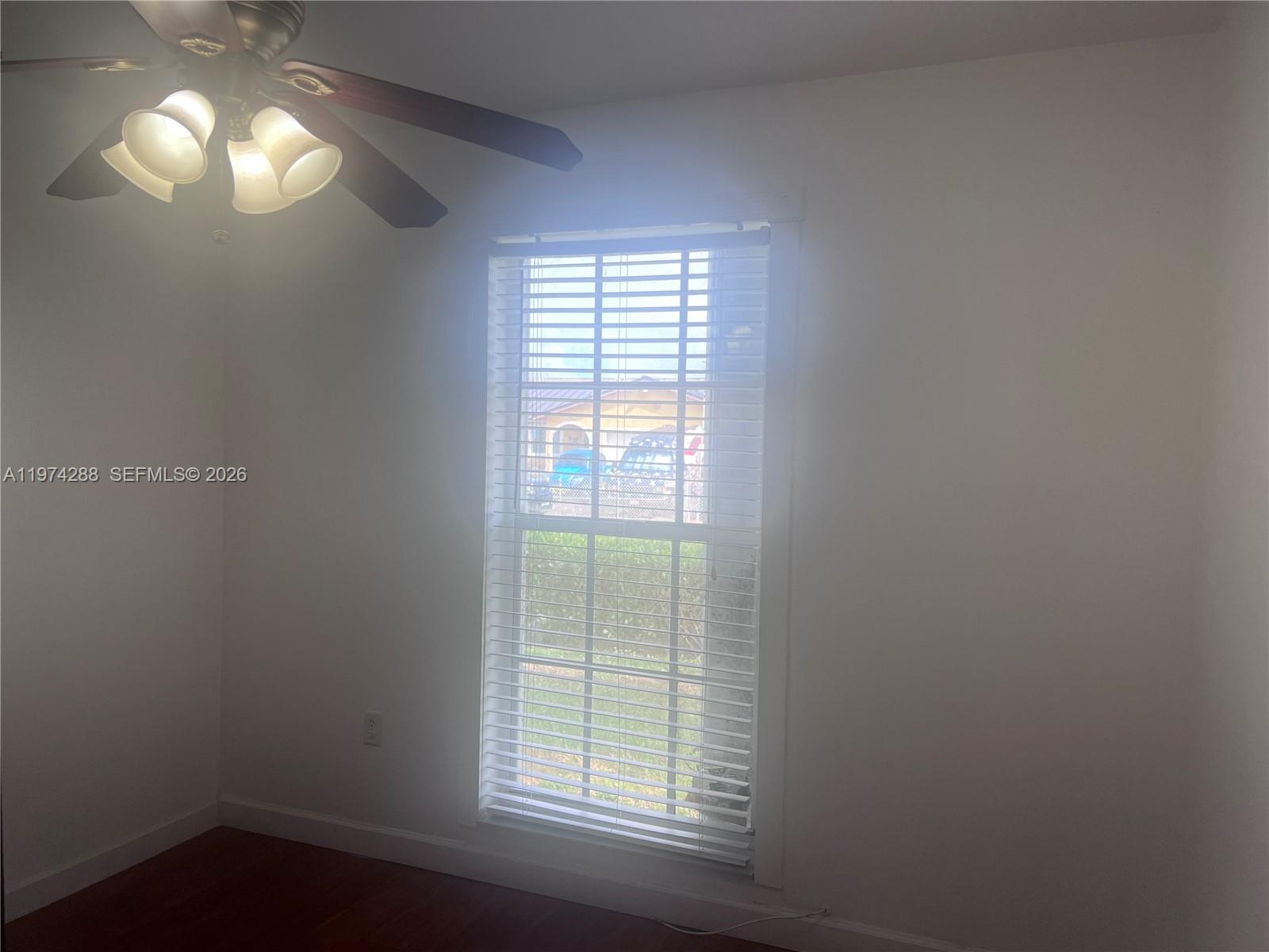 26120 Southwest 130th Avenue Homestead, FL 33032 - Photo 28 of 34 wooden floor in an empty room with a window