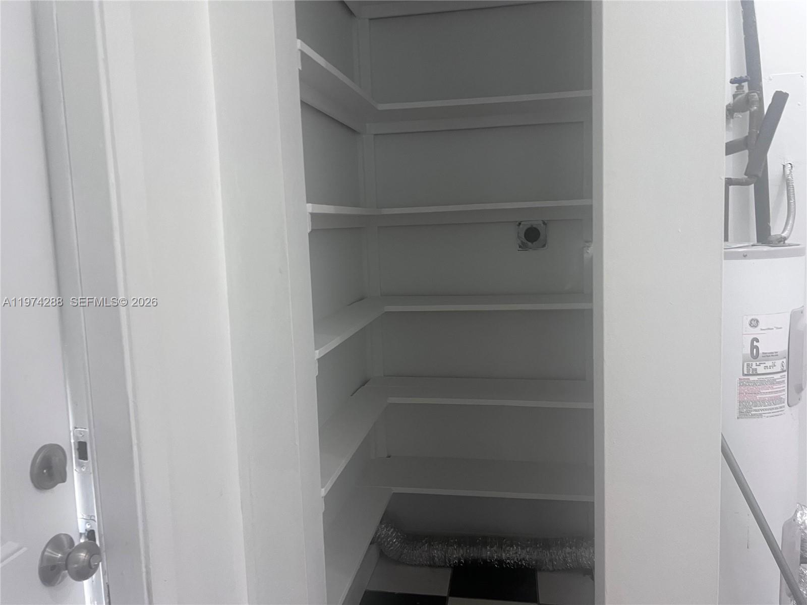 26120 Southwest 130th Avenue Homestead, FL 33032 - Photo 31 of 34 a view of walk in closet with empty racks