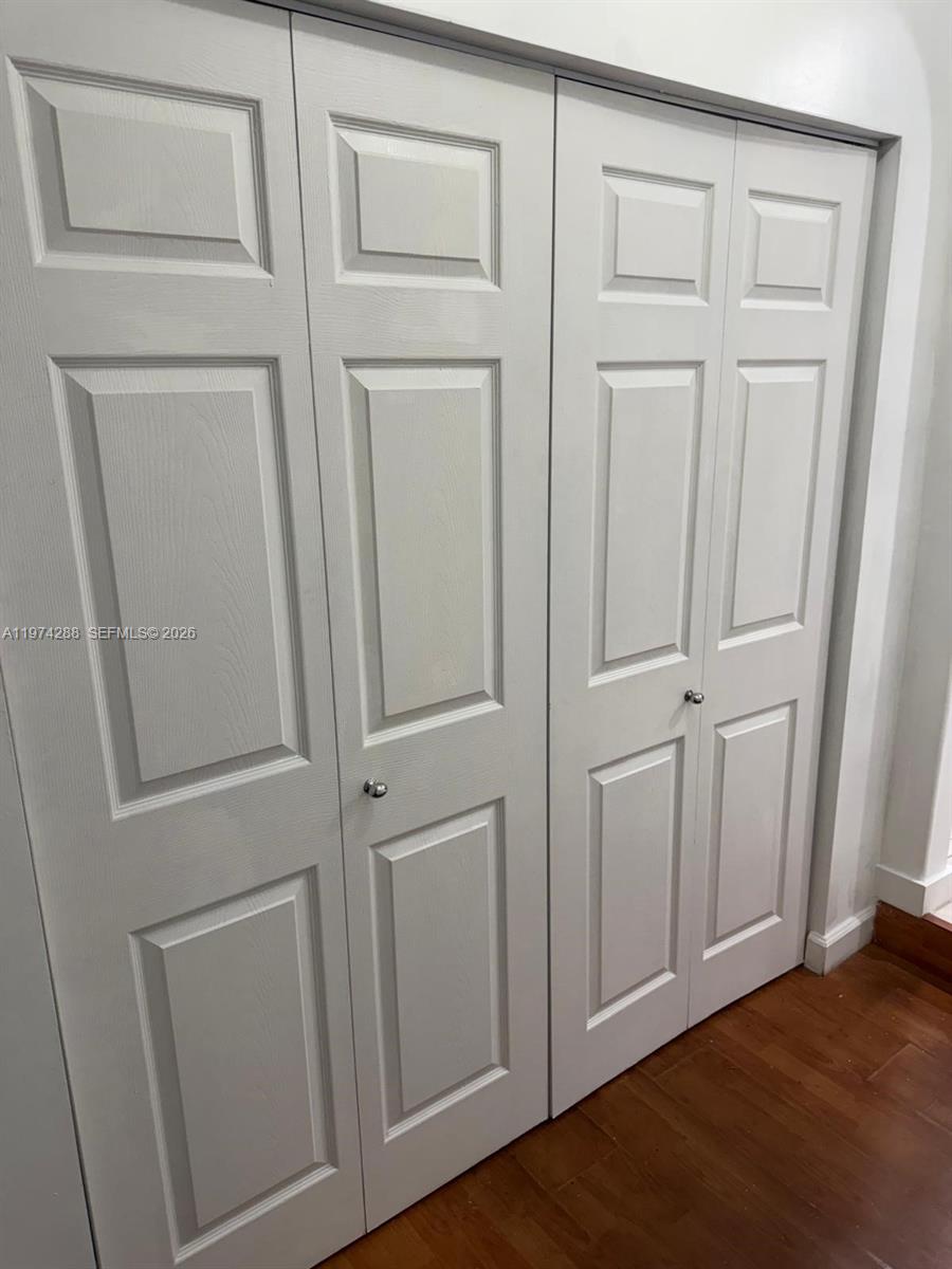 26120 Southwest 130th Avenue Homestead, FL 33032 - Photo 33 of 34 a view of a closet area with hardwood floor