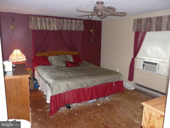 6158 Telegraph Road Elkton, MD 21921 - Photo 2 of 12 a bed sitting in a bedroom next to a window