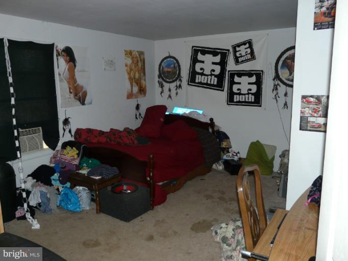 6158 Telegraph Road Elkton, MD 21921 - Photo 8 of 12 a bed room with a bed and a potted plant