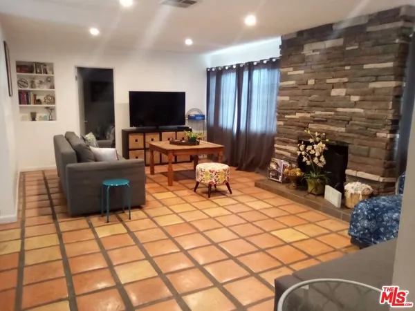 a living room with couches and a flat screen tv