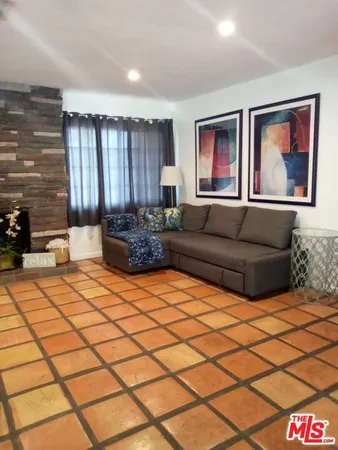 a living room with a couch and a stove top oven