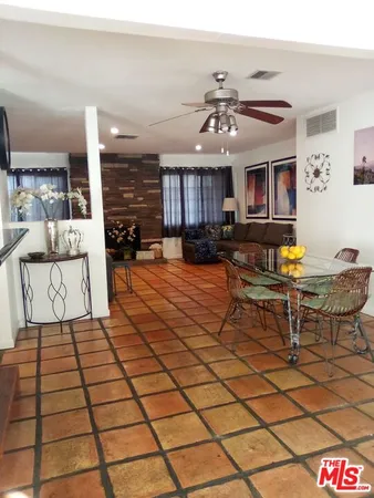 a living room with furniture and kitchen view