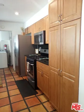a kitchen with stainless steel appliances a refrigerator and cabinets
