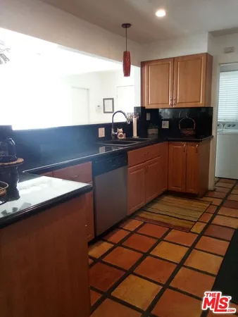 a kitchen with stainless steel appliances a sink stove and cabinets