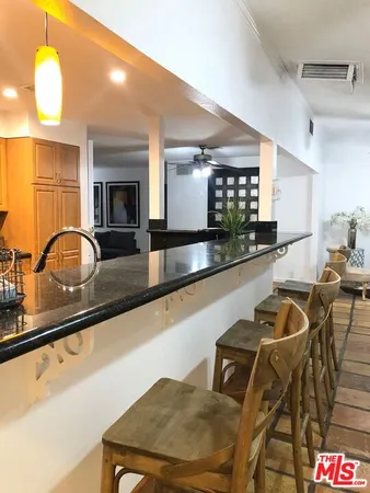 a kitchen with a sink and a stove top oven
