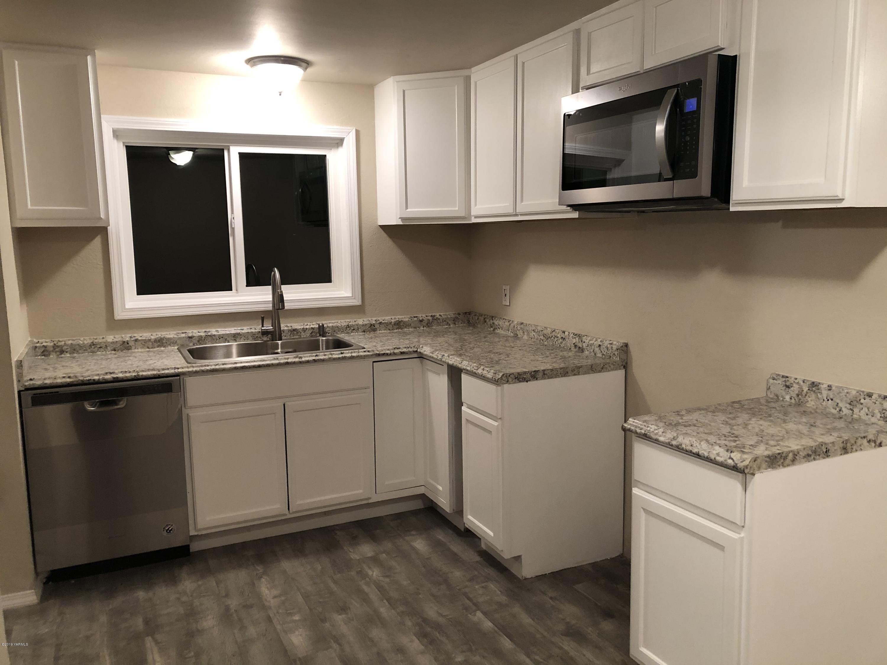 4930 Lateral A Road Wapato, WA 98951 - Photo 8 of 19 a kitchen with stainless steel appliances granite countertop a sink and a microwave