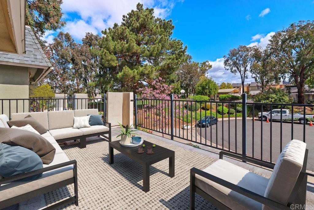 a view of a patio with couches chairs and wooden floor