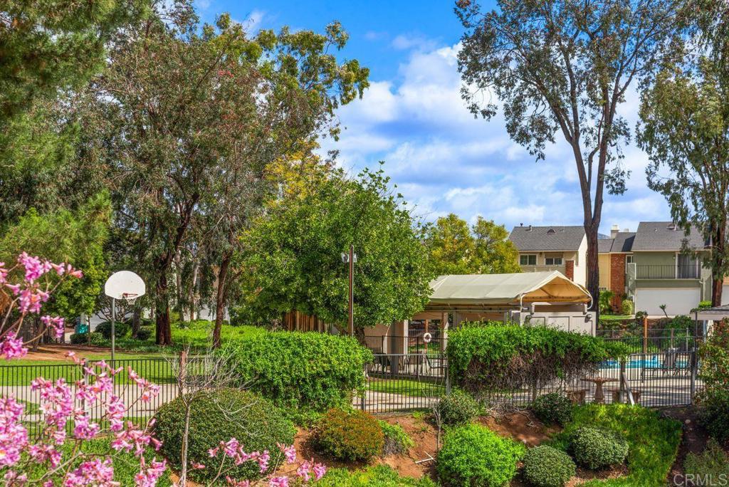 12939 Cree Court Poway, CA 92064 - Photo 2 of 15 a front view of a house with a yard and fountain in middle