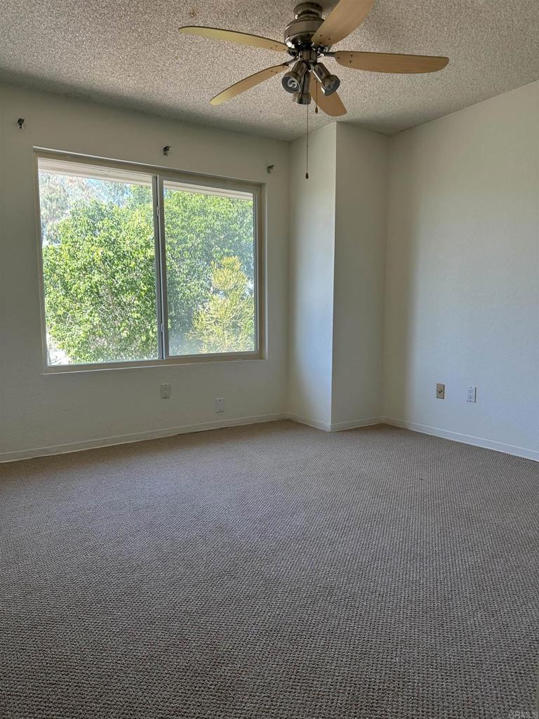 12939 Cree Court Poway, CA 92064 - Photo 8 of 15 an empty room with a window and a fan