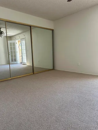 an empty room with a fireplace and windows
