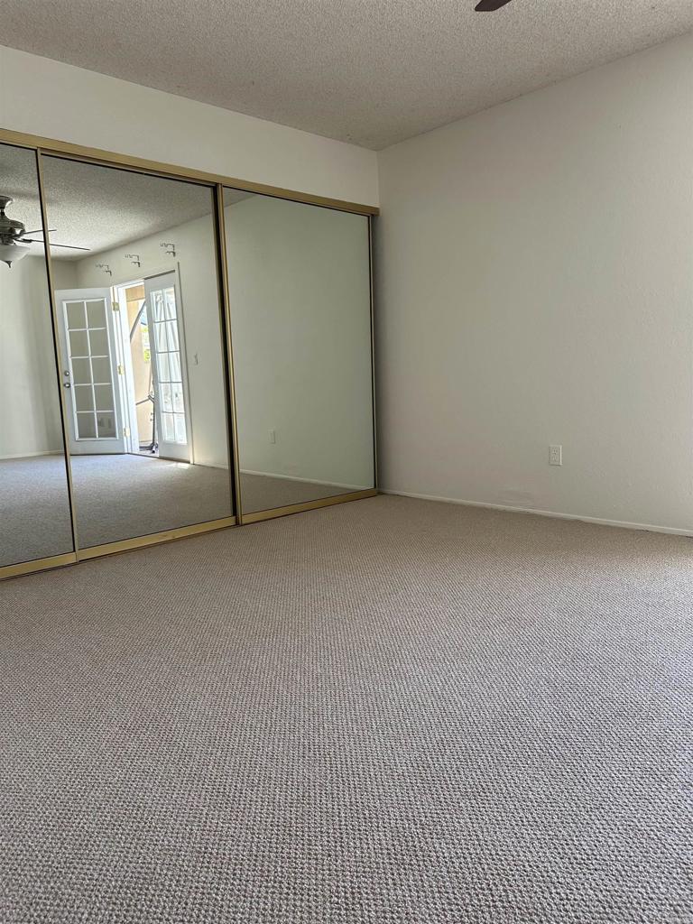 12939 Cree Court Poway, CA 92064 - Photo 9 of 15 an empty room with a fireplace and windows