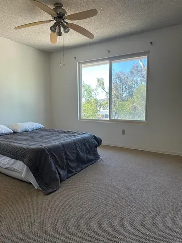 a bedroom with a bed and window