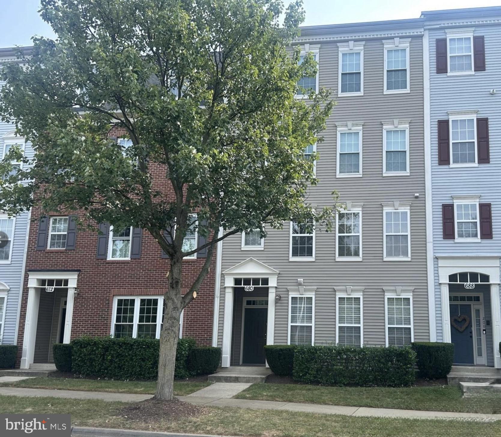 680 Orchard Ridge Drive, Unit 100 Gaithersburg, MD 20878 - Photo 1 of 25 a front view of a building with a garden