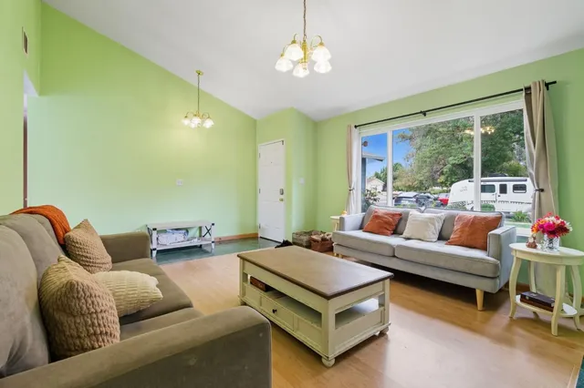 a living room with furniture and a chandelier