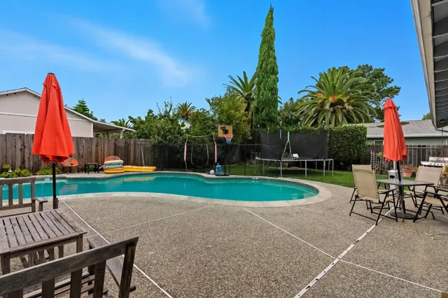 a view of a table and chairs in patio of a house