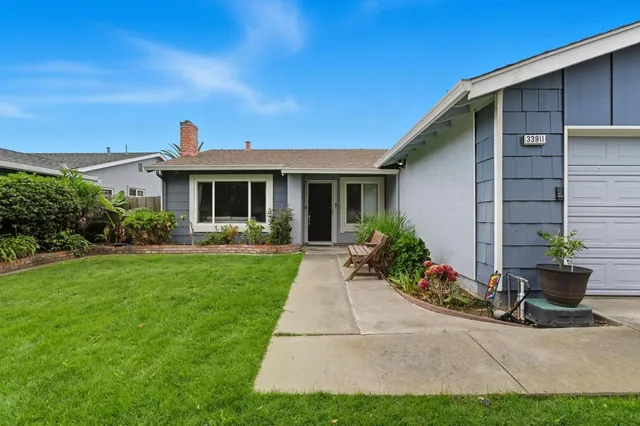 a front view of a house with garden