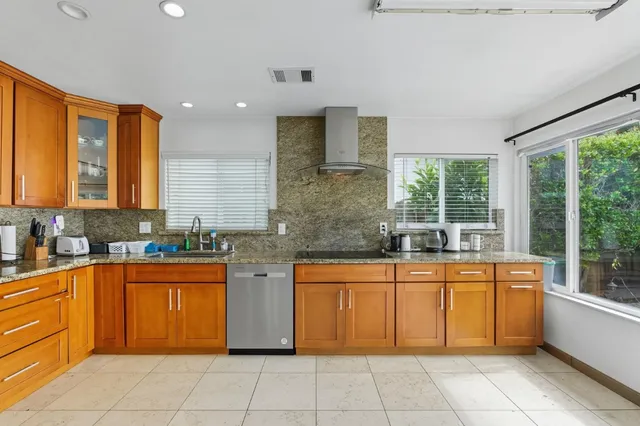 a kitchen with a sink window and cabinets
