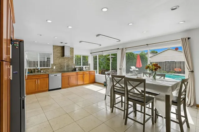 a kitchen with stainless steel appliances kitchen island granite countertop a sink and cabinets