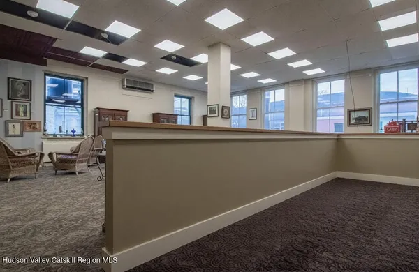 a kitchen with a refrigerator and a wooden floor