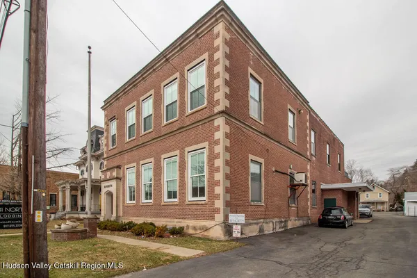 a view of a building with car parked