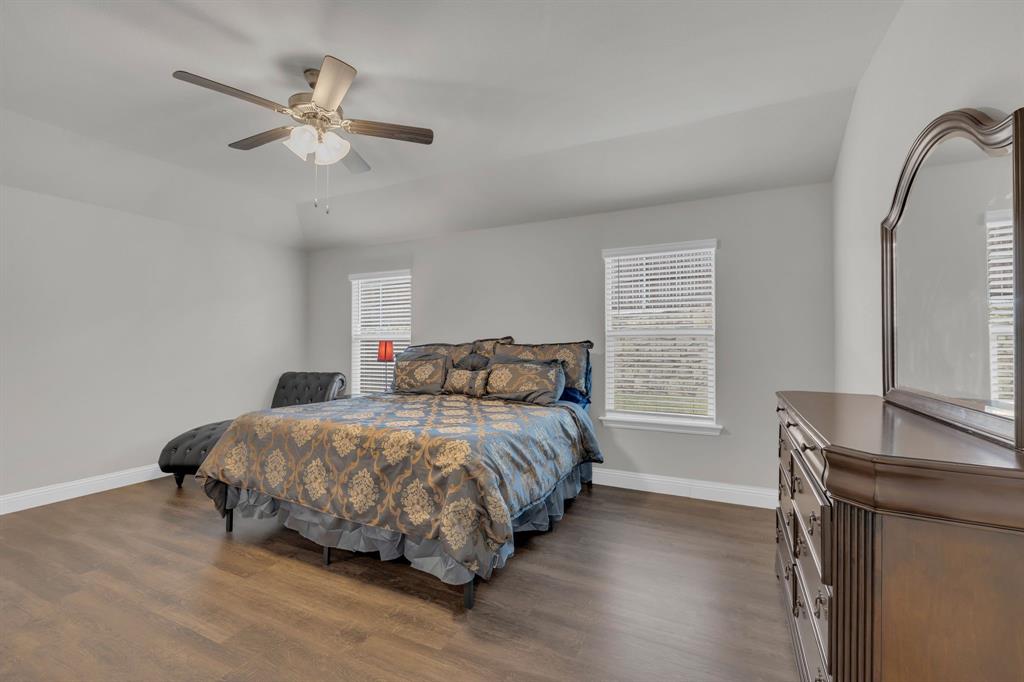 728 Golden Gate Pk Road Alvarado, TX 76009 - Photo 11 of 23 Bedroom with multiple windows, dark wood-type flooring, a ceiling fan, and vaulted ceiling