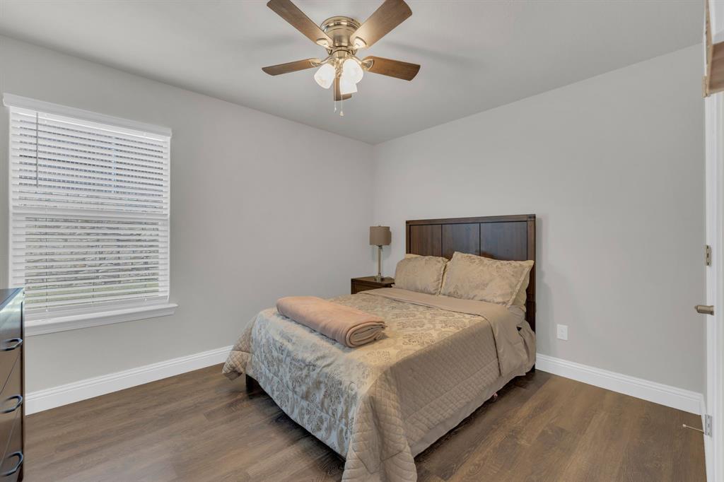 728 Golden Gate Pk Road Alvarado, TX 76009 - Photo 14 of 23 Bedroom featuring wood finished floors and a ceiling fan
