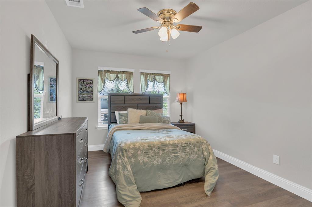 728 Golden Gate Pk Road Alvarado, TX 76009 - Photo 16 of 23 Bedroom with dark wood finished floors and a ceiling fan