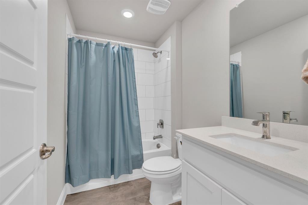 728 Golden Gate Pk Road Alvarado, TX 76009 - Photo 17 of 23 Bathroom with vanity, shower / bath combination with curtain, and light wood-style flooring
