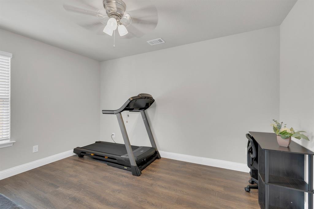 728 Golden Gate Pk Road Alvarado, TX 76009 - Photo 18 of 23 Exercise room with dark wood-type flooring and ceiling fan