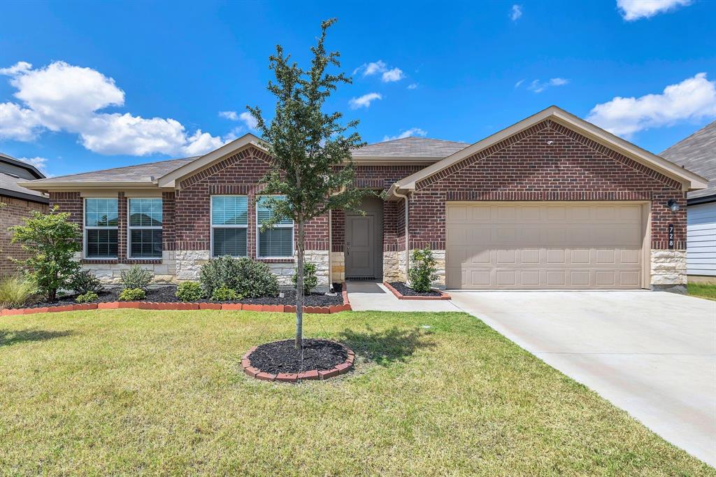 728 Golden Gate Pk Road Alvarado, TX 76009 - Photo 4 of 23 Ranch-style house featuring a garage, driveway, a front yard, and stone siding