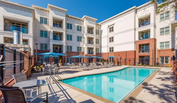 a view of a swimming pool with outdoor seating