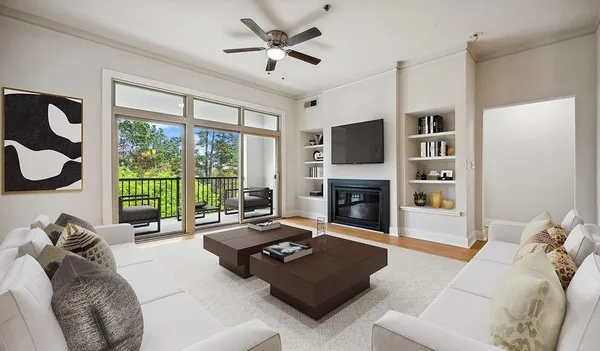 a living room with furniture a fireplace and a flat screen tv