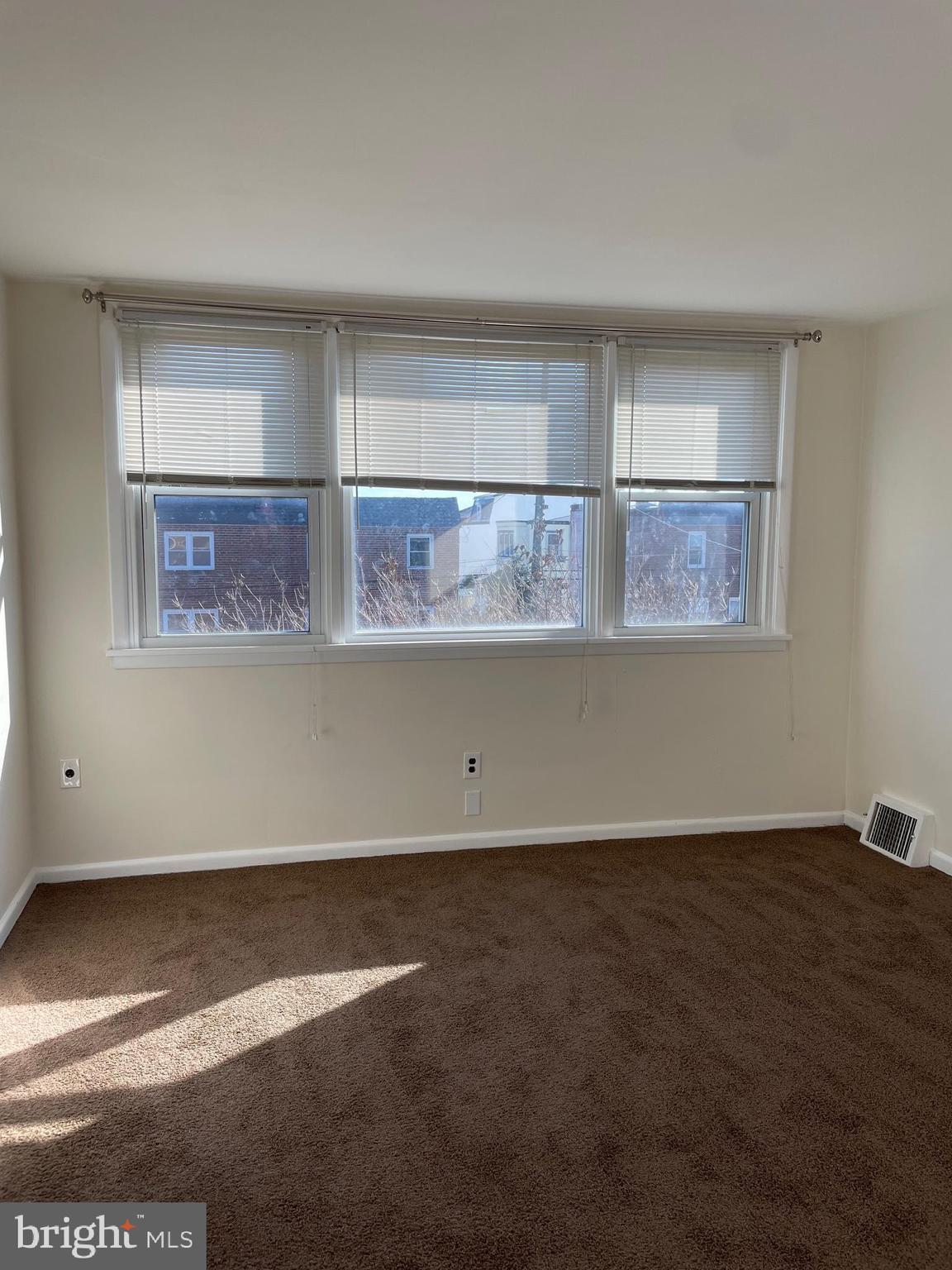 8412 Jackson Street Philadelphia, PA 19136 - Photo 21 of 45 an empty room with wooden floor and window