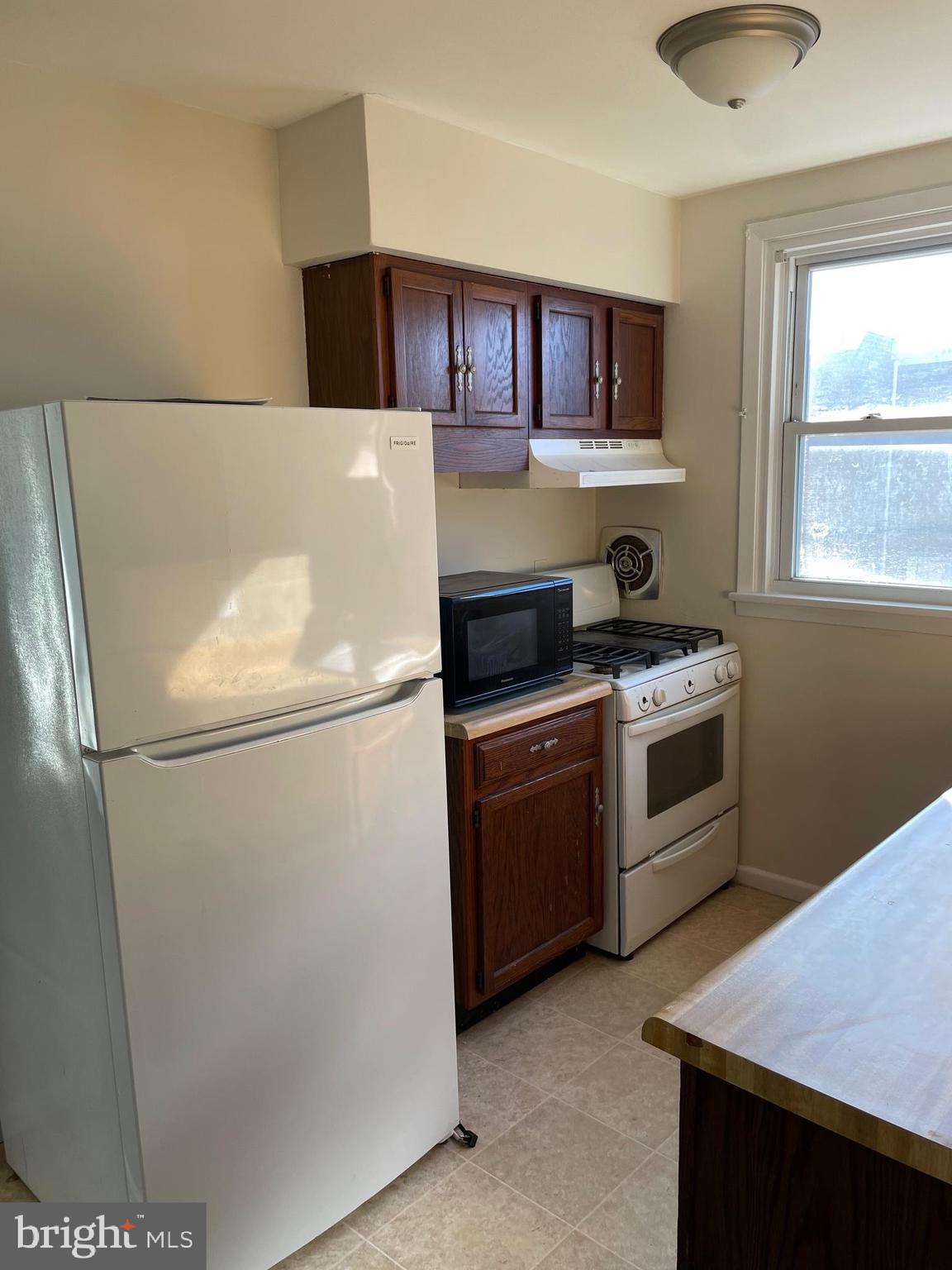 8412 Jackson Street Philadelphia, PA 19136 - Photo 27 of 45 a white refrigerator freezer sitting inside of a kitchen