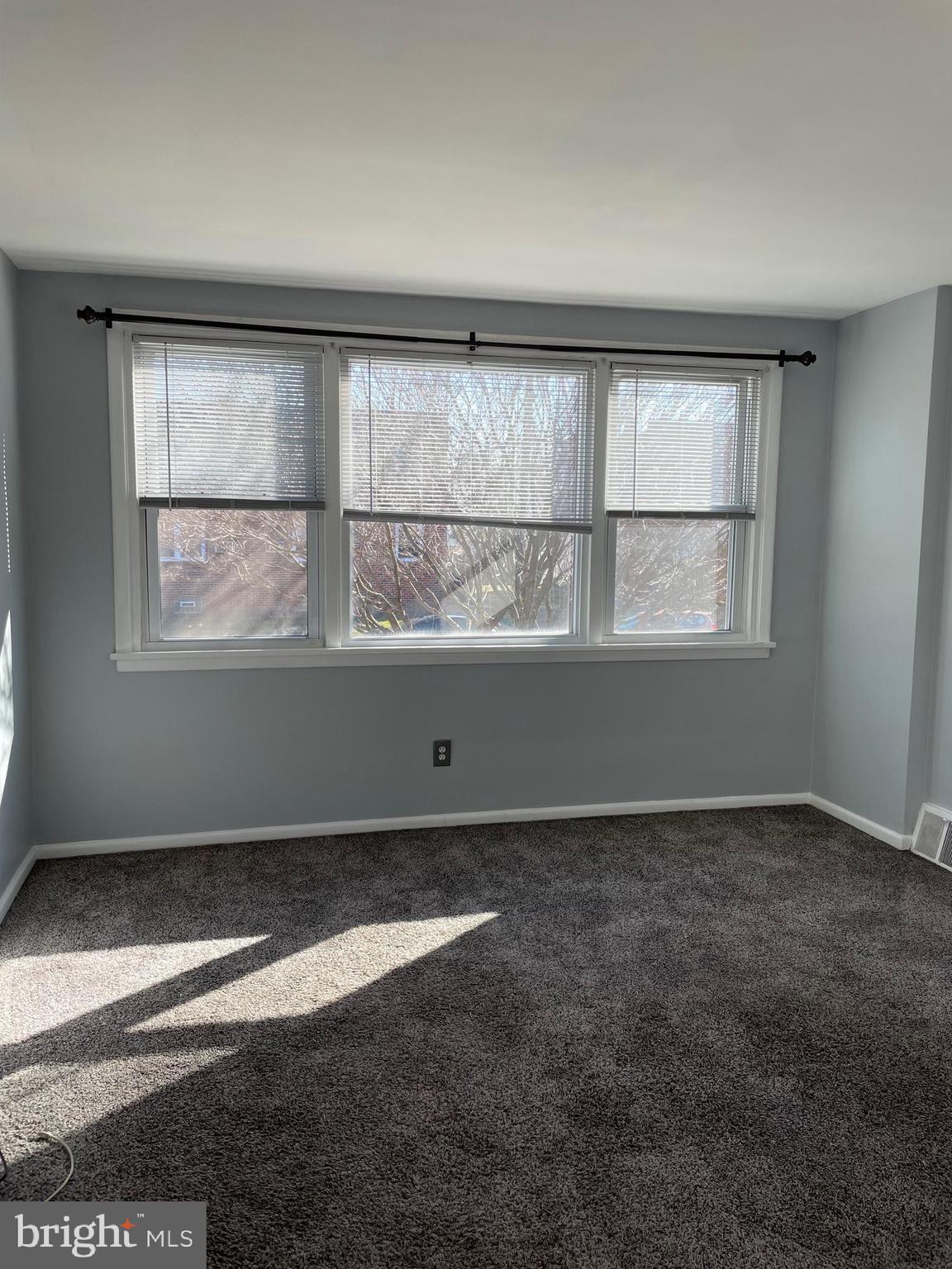 8412 Jackson Street Philadelphia, PA 19136 - Photo 5 of 45 an empty room with wooden floor and windows