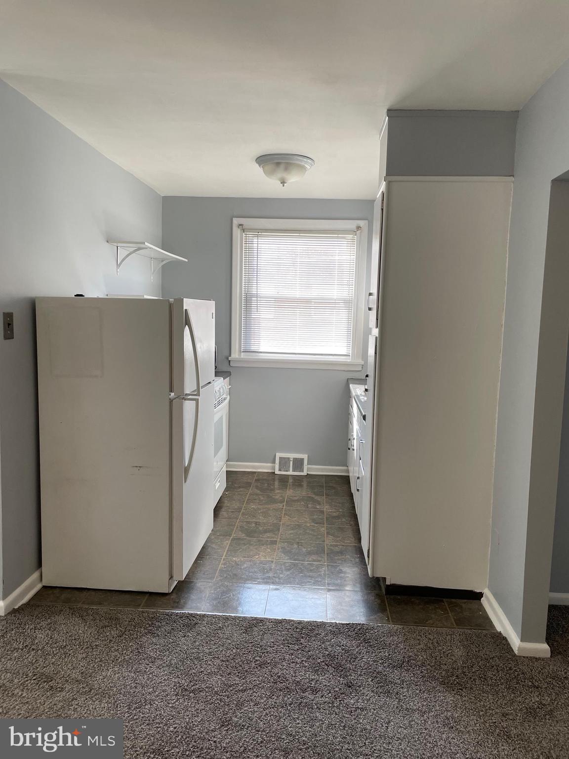 8412 Jackson Street Philadelphia, PA 19136 - Photo 9 of 45 a view of a refrigerator in kitchen and an empty room